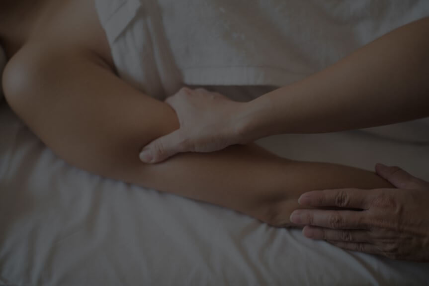 Person receiving an arm massage from a therapist.